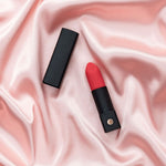 Lovense Exomoon Mini Lipstick Vibrator, Vibrator on Pink Bedsheets