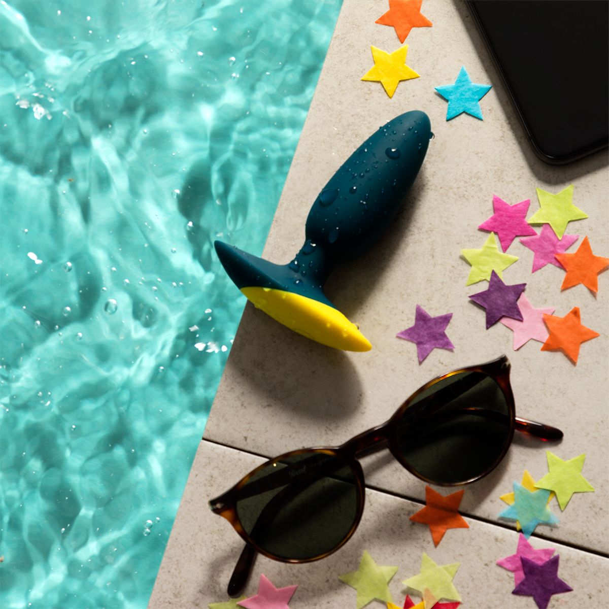 Romp Bass Vibrating Anal Plug, Product Beside Sunglasses by The Pool Side