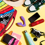 Romp Clitoral & G-Spot Stimulator, Product Beside Bag with Other Personal Novelties