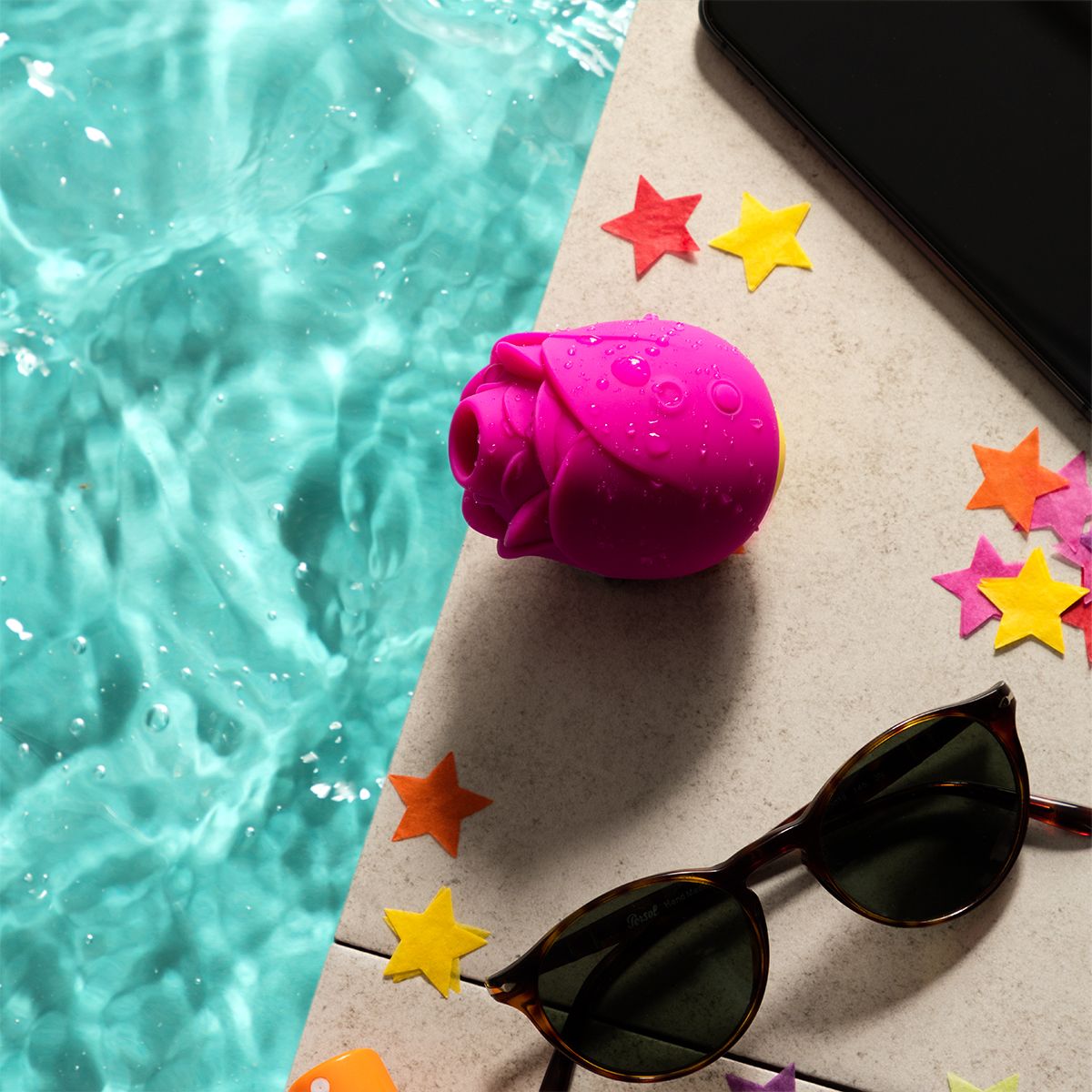 ROMP Rose Clitoral Stimulator, Product Beside Sunglass by the Pool Side