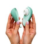 Womanizer Liberty 2 Clitoral Stimulator, Sage, Clitoral Stimulator in Right and Cover Lid in Left Hand